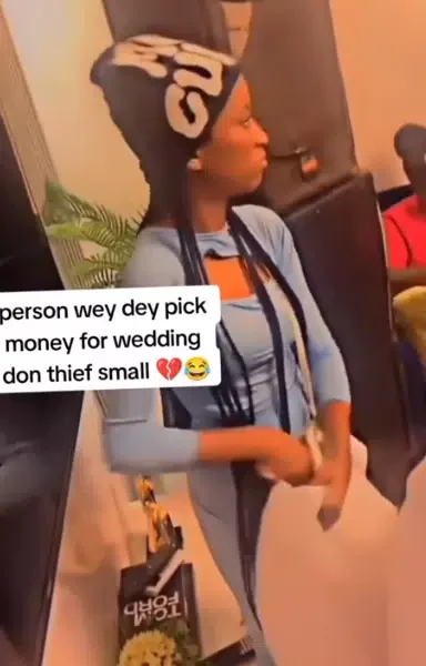 'Someone's serious babe' - Video of lady stealing couple's money at wedding causes buzz