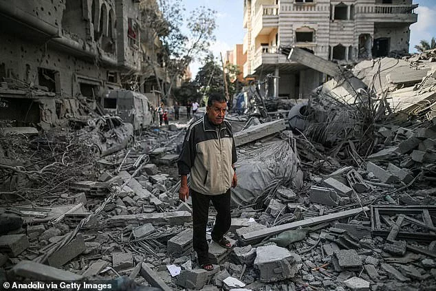 A man walks across the rubble after an Israeli attack on Nuseirat Camp in Gaza on November 17, 2023