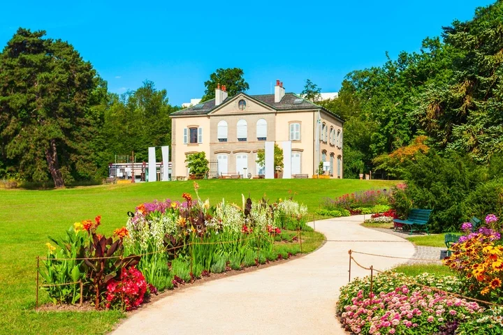 Image may contain Architecture Building Housing Bench Furniture House Grass Plant Outdoors and Manor