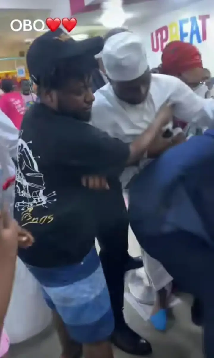 Moment overzealous fan nearly drags Davido to the ground