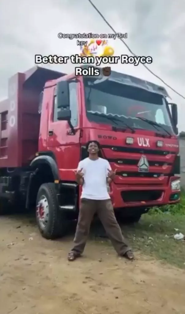Young man celebrates as he acquires tipper truck