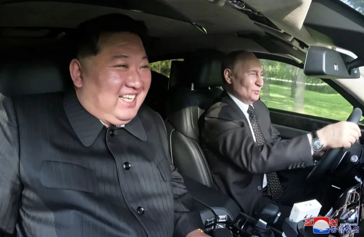 Putin driving with his ally Kim Jong-Un