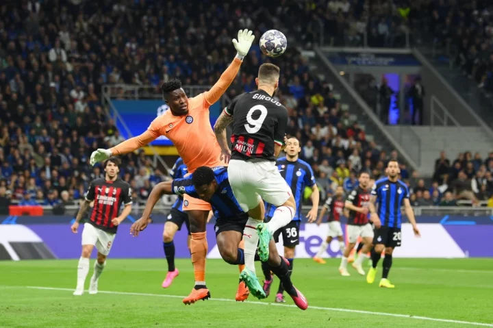 MILAN, ITALY - MAY 16: Andre Onana of FC Internazionale jumps for the ball with Olivier Giroud of AC Milan during the UEFA Champions League semi-final second leg match between FC Internazionale and AC Milan at Stadio Giuseppe Meazza on May 16, 2023 in Milan, Italy. (Photo by Mike Hewitt/Getty Images)