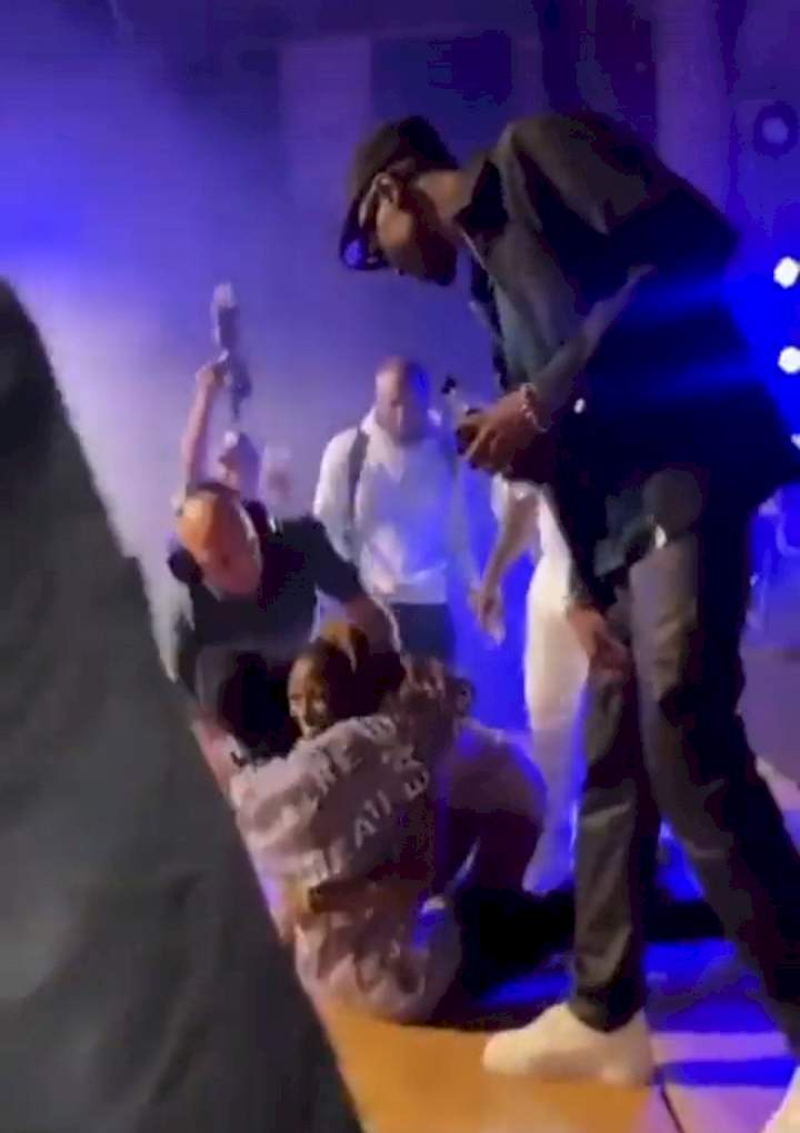 Female fan led off stage after she mounted singer Omah Lay during his performance in Sweden (video)