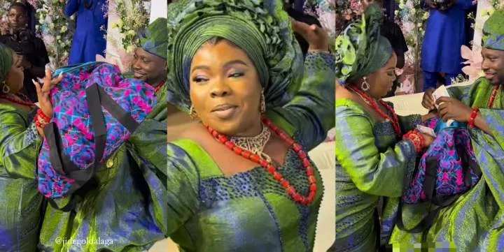 Beautiful bride causes stir as she packs money in a Ghana must-go bag on her wedding day (Video)