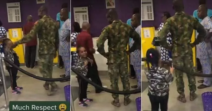 Nigerian soldier reacts as little girl walks up to him inside bank, salutes him (Video)