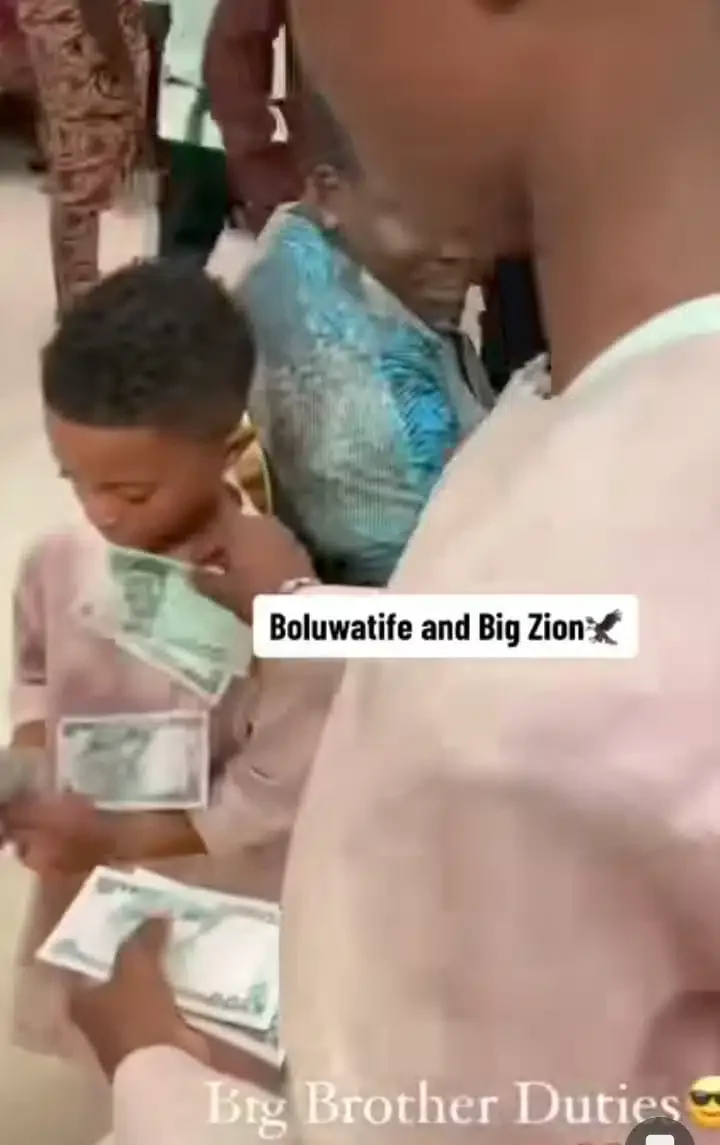 'Big bro duties' - Adorable moment Wizkid's first son, Boluwatife sprays money on his junior brother, Zion