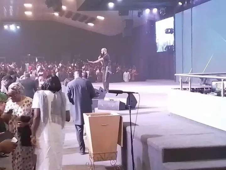 Alarm as pastor mounts pulpit to preach with AK-47 rifle in Abuja (Video)