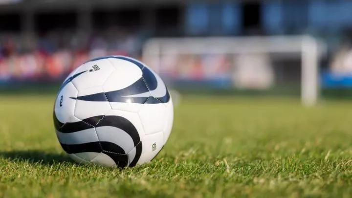 Football ball on sports field close up stock photo