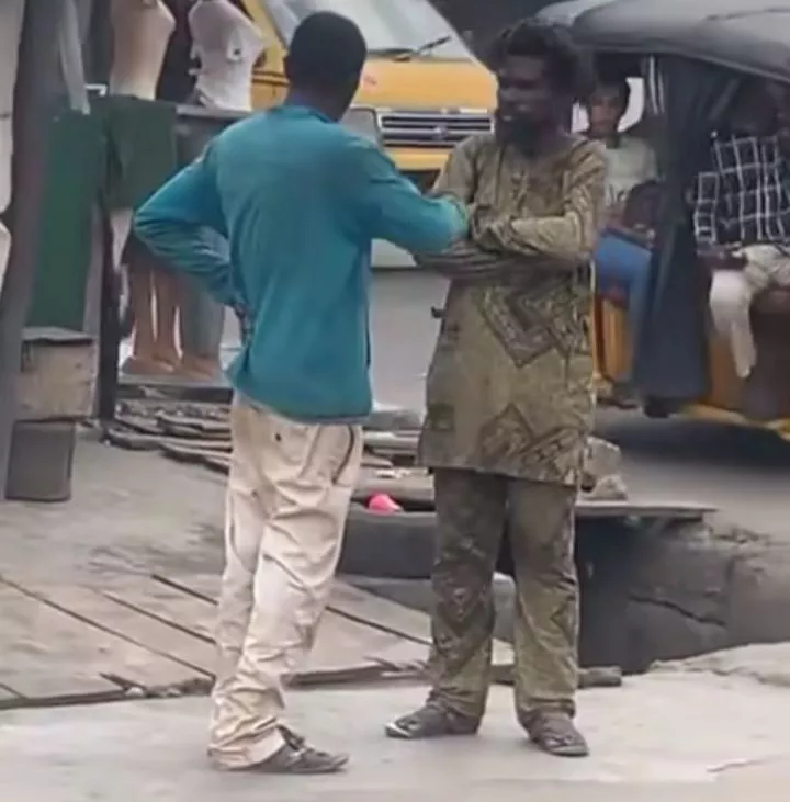 Moment two mentally challenged men were spotted conversing on a busy street