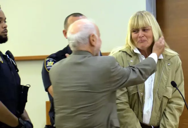 Woman who served 13 years is freed from prison after new evidence contradicted accounts that she helped a hitman commit murder