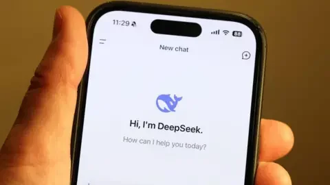 Getty Images Hand holding smartphone, showing DeepSeek logo 