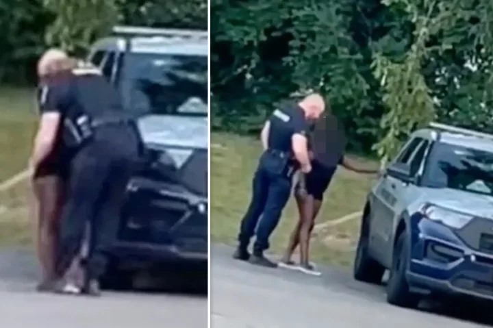 US police suspend officer caught in viral video kissing scantily clad woman before climbing into back of squad car with her (video)