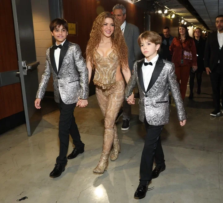 Shakira walking backstage at the Grammy Awards with her two sons.