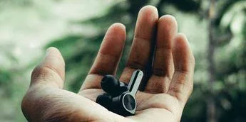 Wireless earphones in a person's hand 