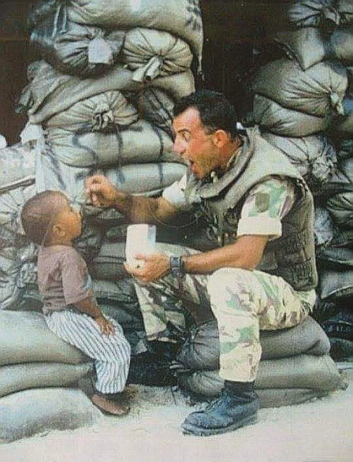 Mogadishu, 1993. An Italian Soldier Gives Food To A Local Orphan