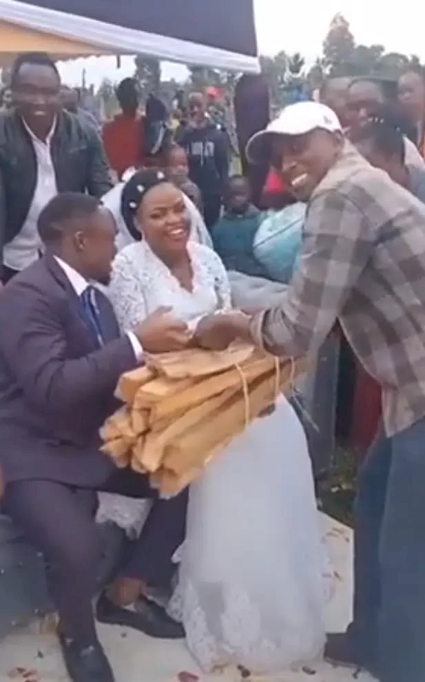'It's a bad omen' - Mixed reactions as man gifts bundle of firewood to couple on wedding day (Video)