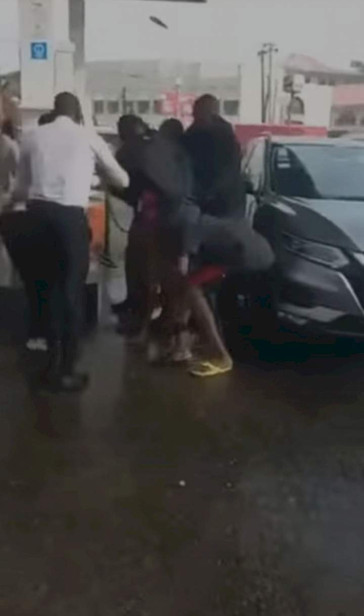 Naked woman causes chaos as she hijacks fuel pump and sprays petrol on customers at petrol station in Falomo, Ikoyi (video)