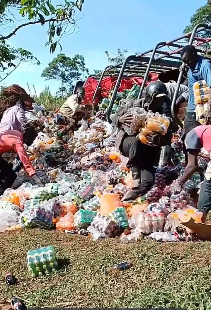 'Christmas came early' - Moment residents rush as truck fully loaded with soft drinks falls