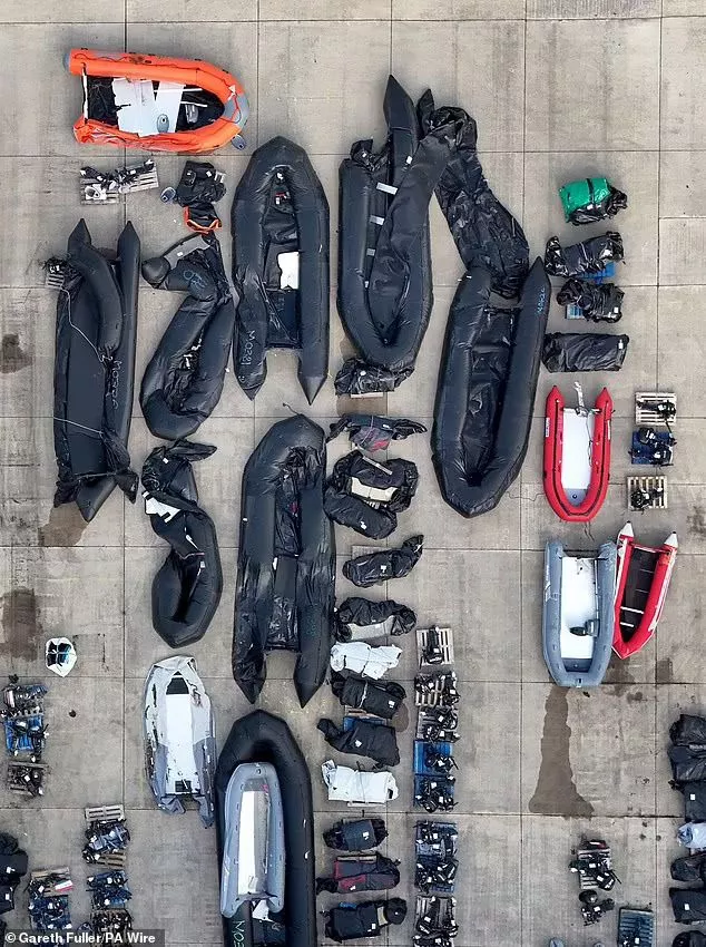 A view of small boats and outboard motors used by people thought to be migrants to cross the Channel at a warehouse facility in Dover, Kent