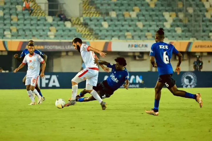 Enyimba's Daniel Daga tackles a Wydad Casablanca player in Uyo