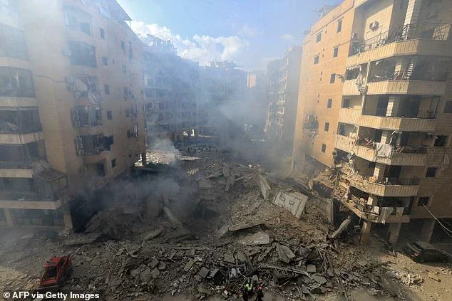 Rescuers check the destruction at the site of an overnight Israeli airstrike in Beirut's southern suburb of Shayyah