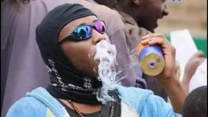 Kenyan protester smokes teargas from canister thrown at him by the Anti-Riot police officers during protests in Kenya (video)