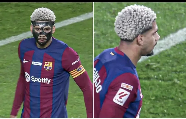 Fans react after Ronald Araujo pulled off his facemask in the first half against Girona on Sunday.