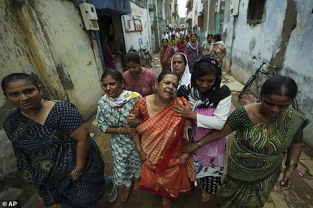 Relatives of those who died in the crash mourn their loved ones during a funeral procession in Ahmedabad last week