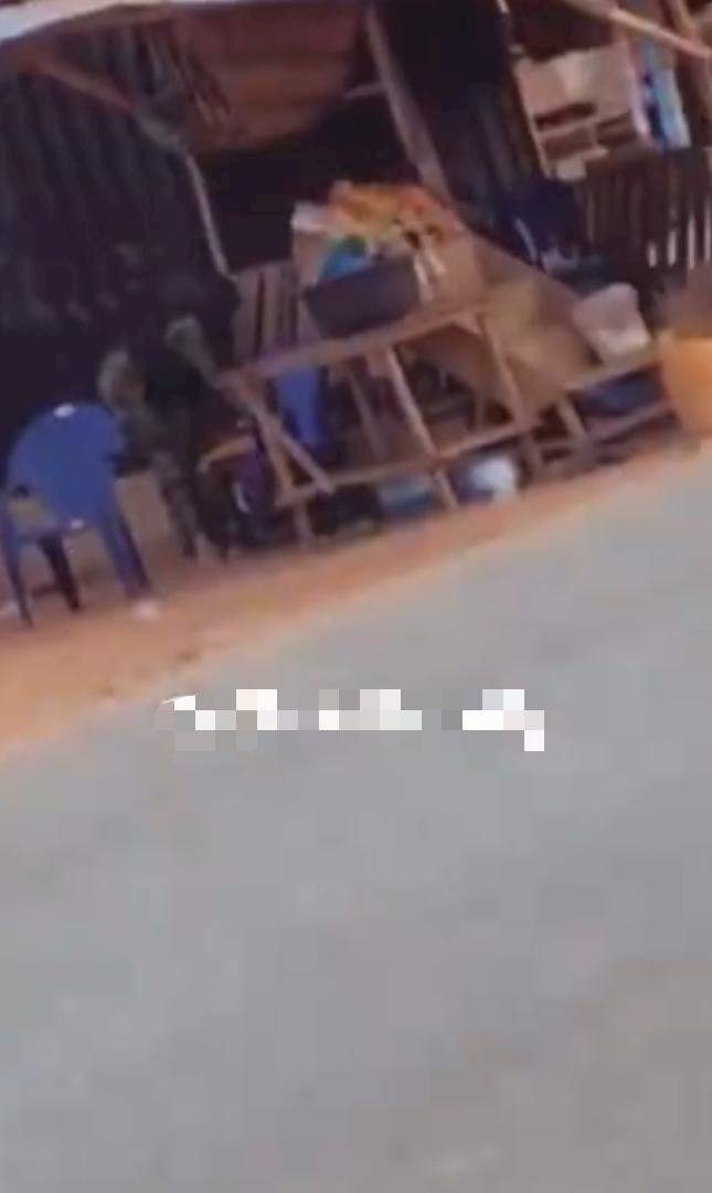 Military men spotted hiding as armed robbers cart away sacks of money in Edo (Video)