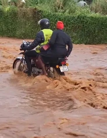 Okada rider causes buzz as woman falls from his bike in attempt to cross flooded road, leaves her drenched in mud water.