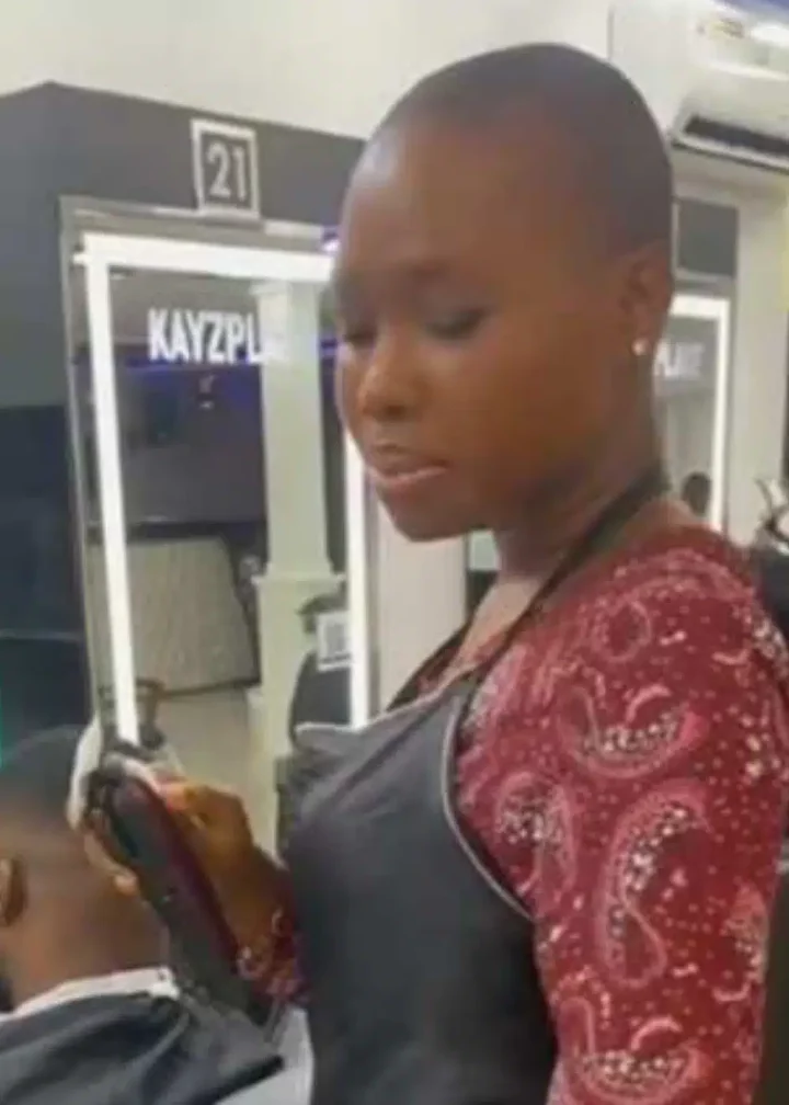 'U dey do home service abeg?' - Reactions as curvy lady barber whines waist as she trims customer's hair (Video)